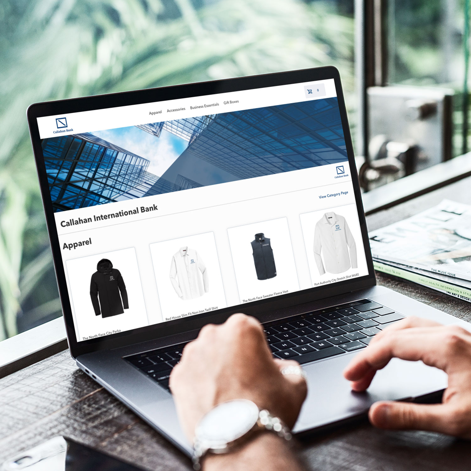 Picture of a person with their hands resting on a laptop with a sample store on the screen.
