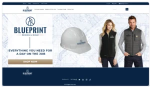 Screenshot of the "Blueprint Design & Build" e-commerce homepage. The main banner features a faded architectural blueprint background with the headline "Everything you need for a day on the job" and a brown "Shop Now" button. To the right, product examples are displayed, including a white branded hard hat and two models wearing a black and a dark grey branded vest. The top navigation menu includes categories for Company Apparel, Jobsite & Safety Gear, Company Goods, and Winter Gear.